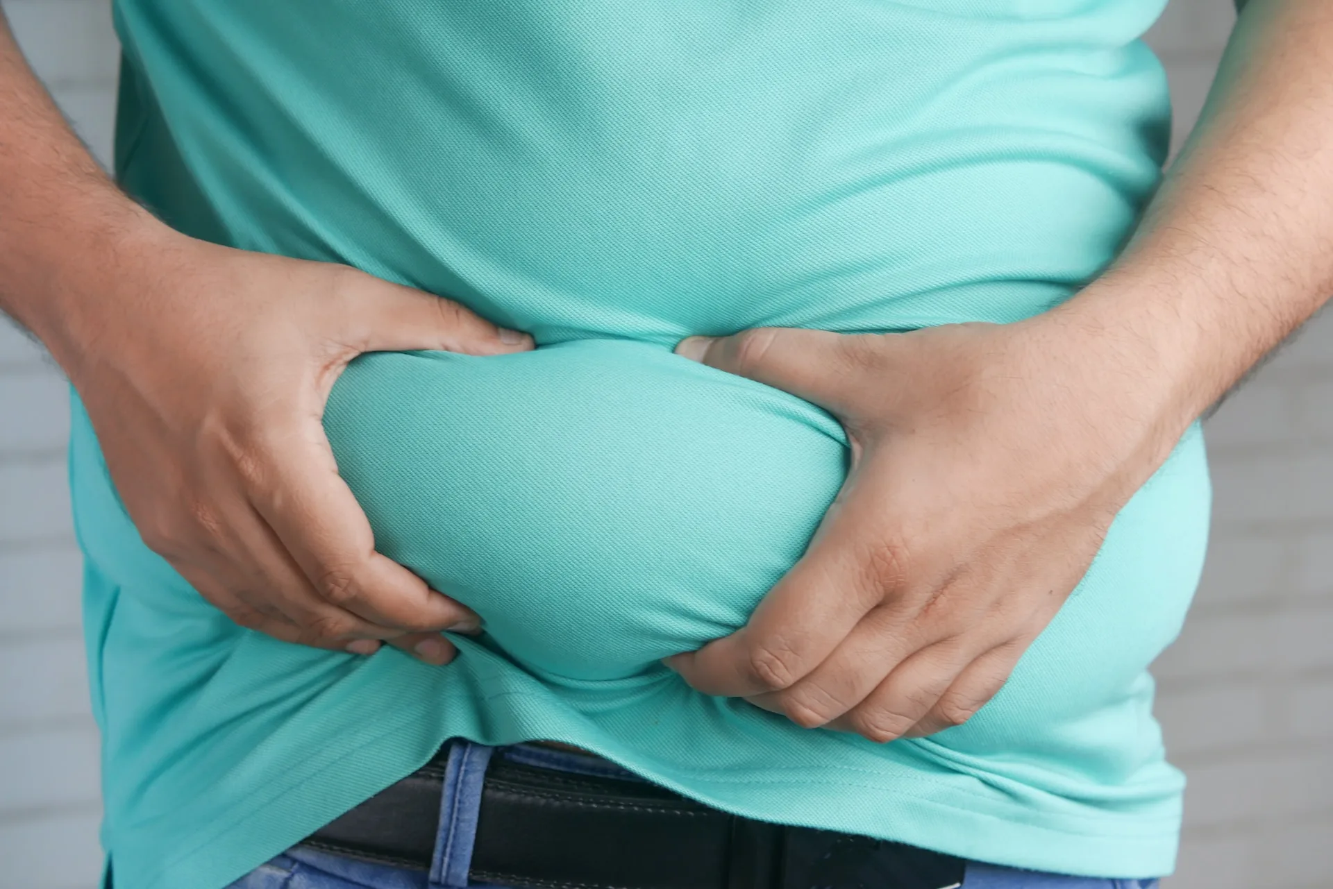 Obese man holding his stomach