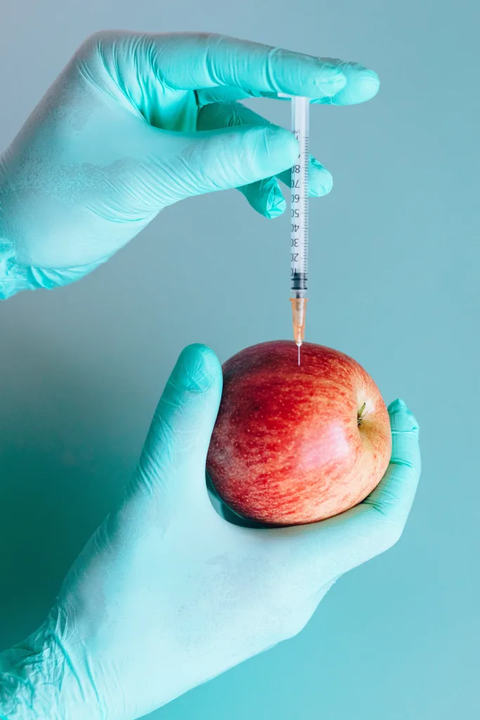 Doctor injecting apple as vitamin injections