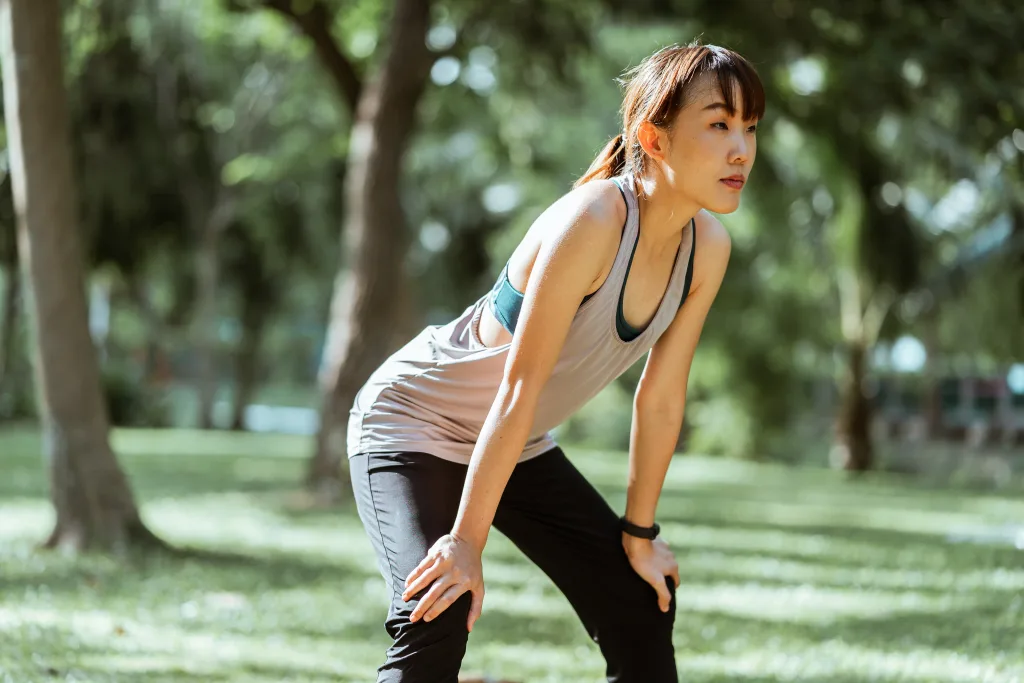 slim woman resting after long jogging