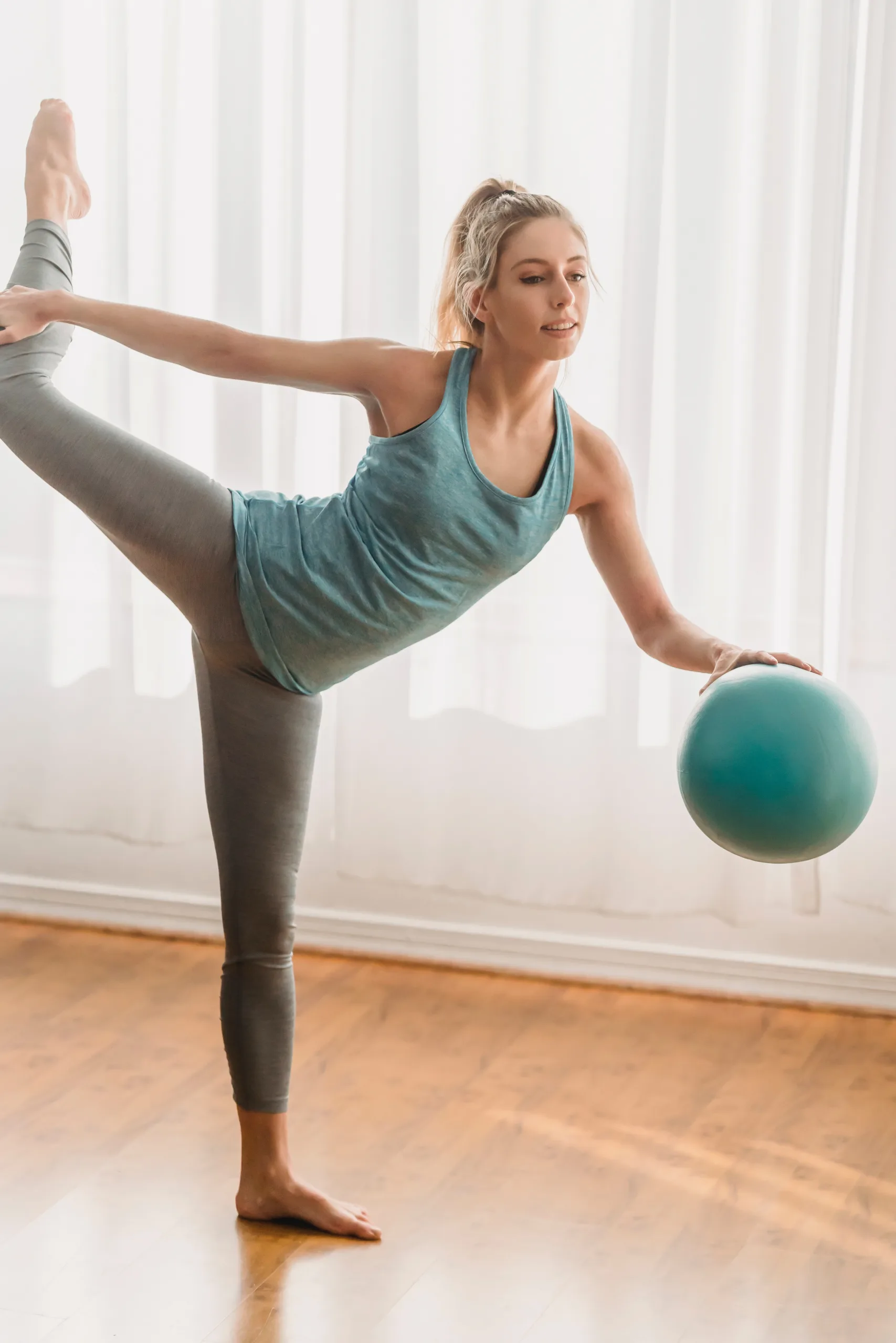 cheerful woman working out with exercise ball blue zones diet
