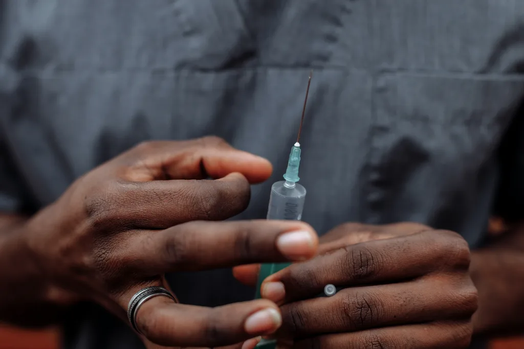 A person checking the syringe injections