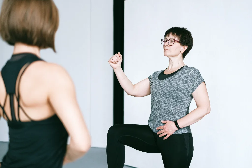 elderly woman warming up with trainer - exotic tastes