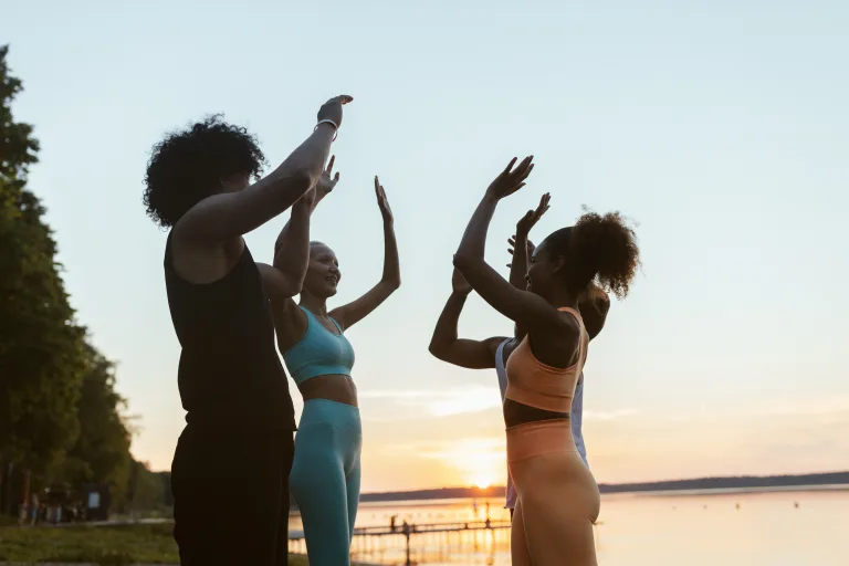 Group of women doing high fives after work out zumba exercises