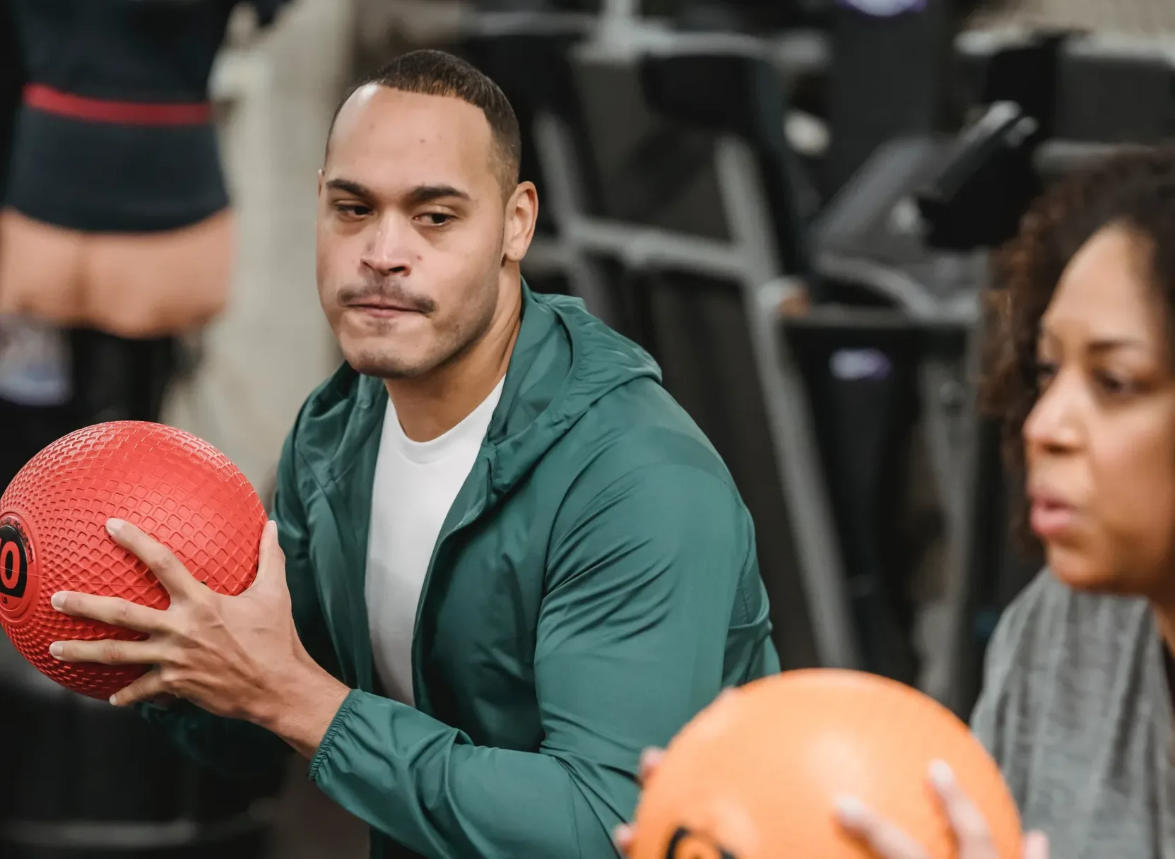 heart man and woman doing intense workout with a ball