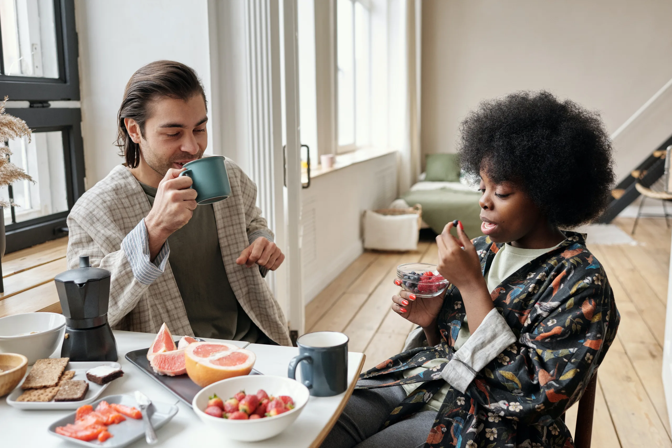 portion control man and woman having healthy breakfast drinking water for intermittent fasting