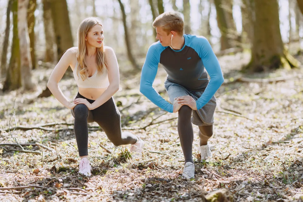 couple stretching near trees for weight loss