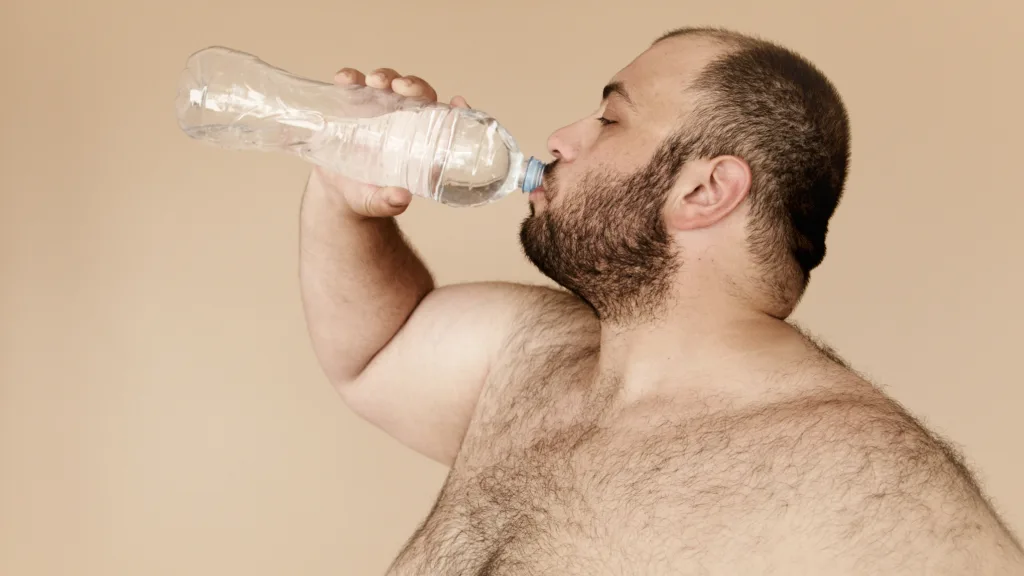 overweight man doing water intake