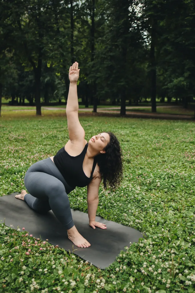 Flexible overweight woman is doing yoga outdoors gene regulation