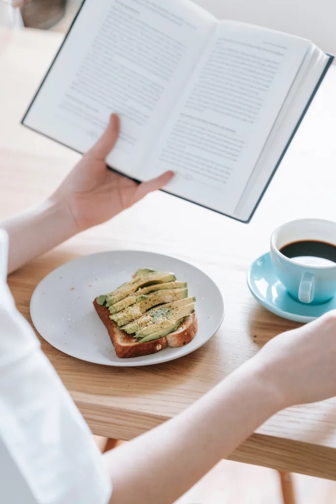 Person reading book and eating meal science-backed benefits