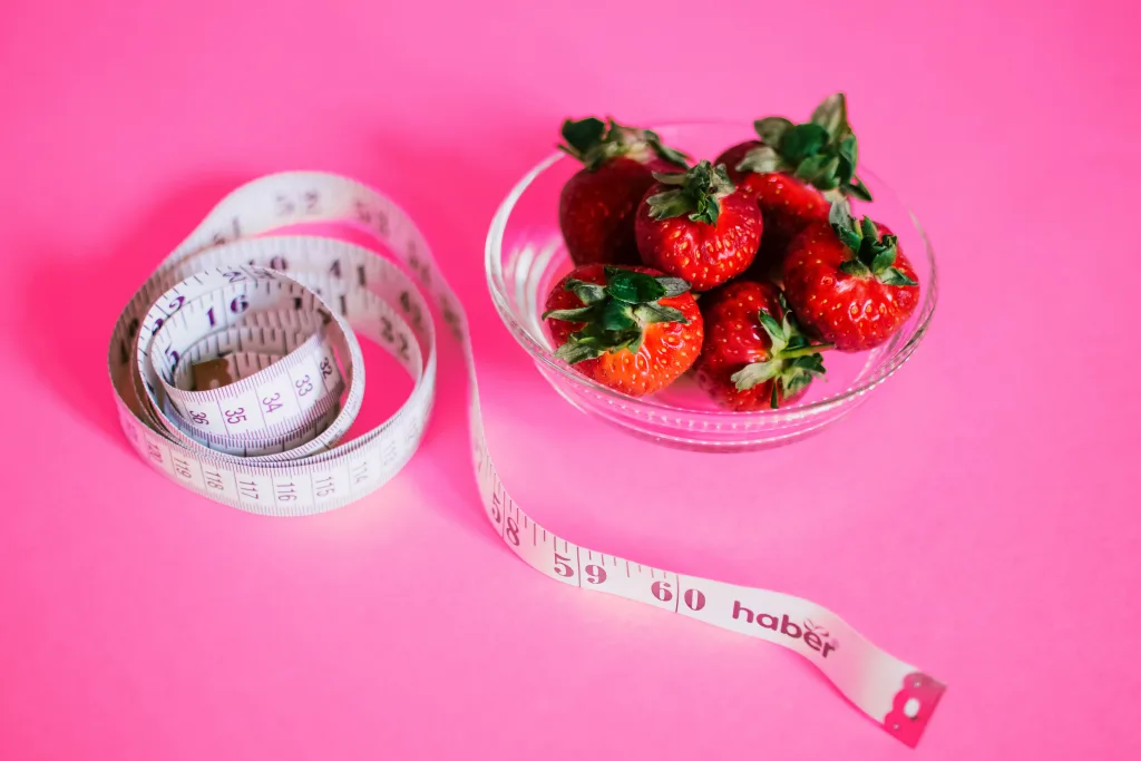 Photo of strawberry and tape meausre