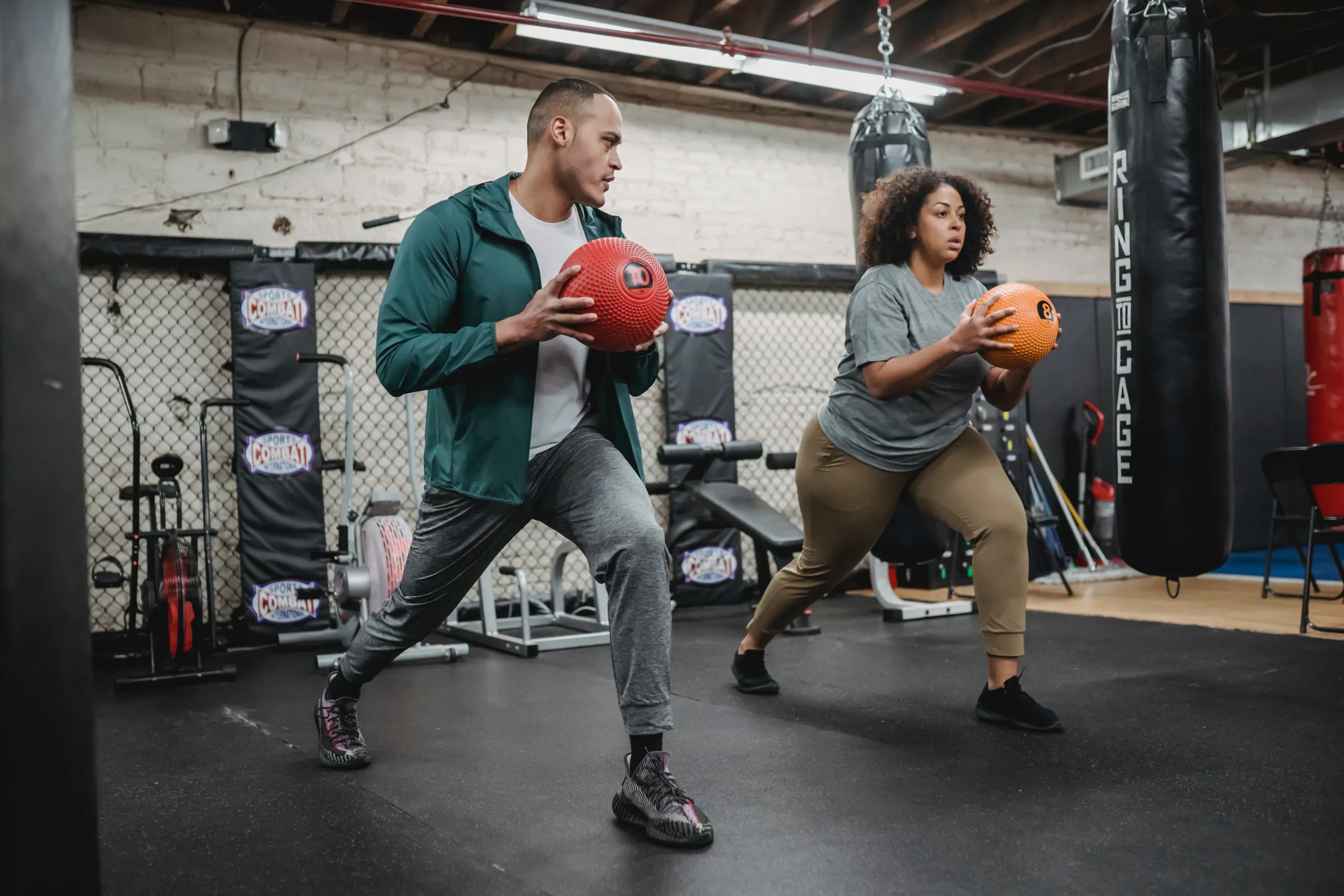 overweight woman with ball accompanied by trainer obesity