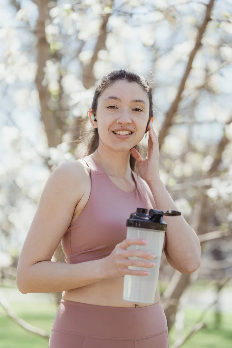 slim woman holding water