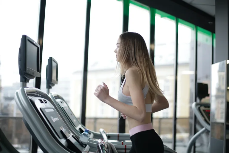 slim woman exercising in treadmill cardiovascular