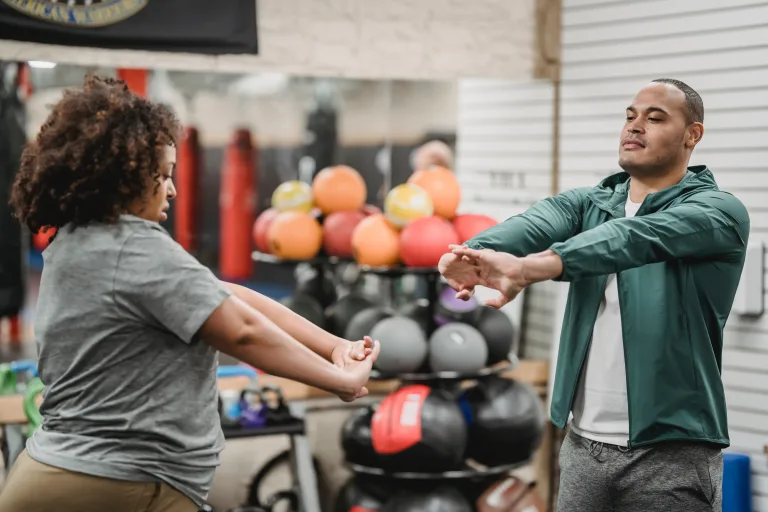 man and woman stretching before exercise which is good for weight loss