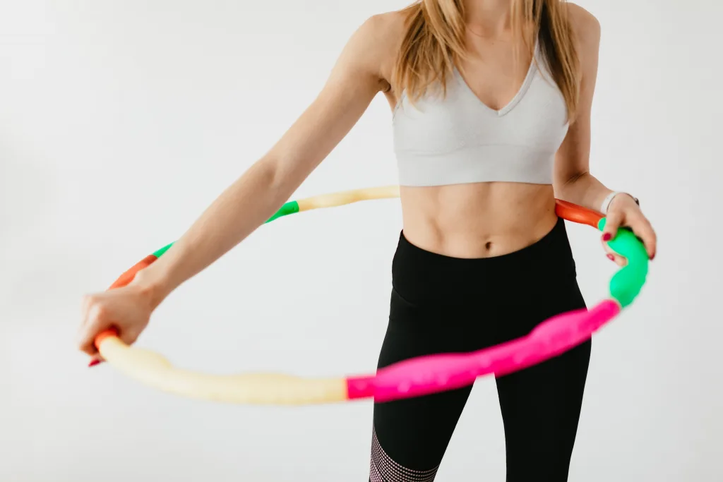 Slim woman doing hula hoops exercise benefit of b12 injections