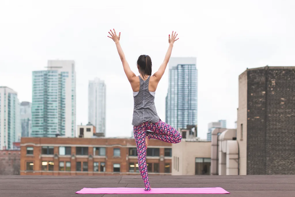 woman doing yoga on the rooftops lifestyle