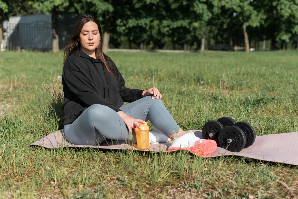 woman preparing for exercise sitting under the sun