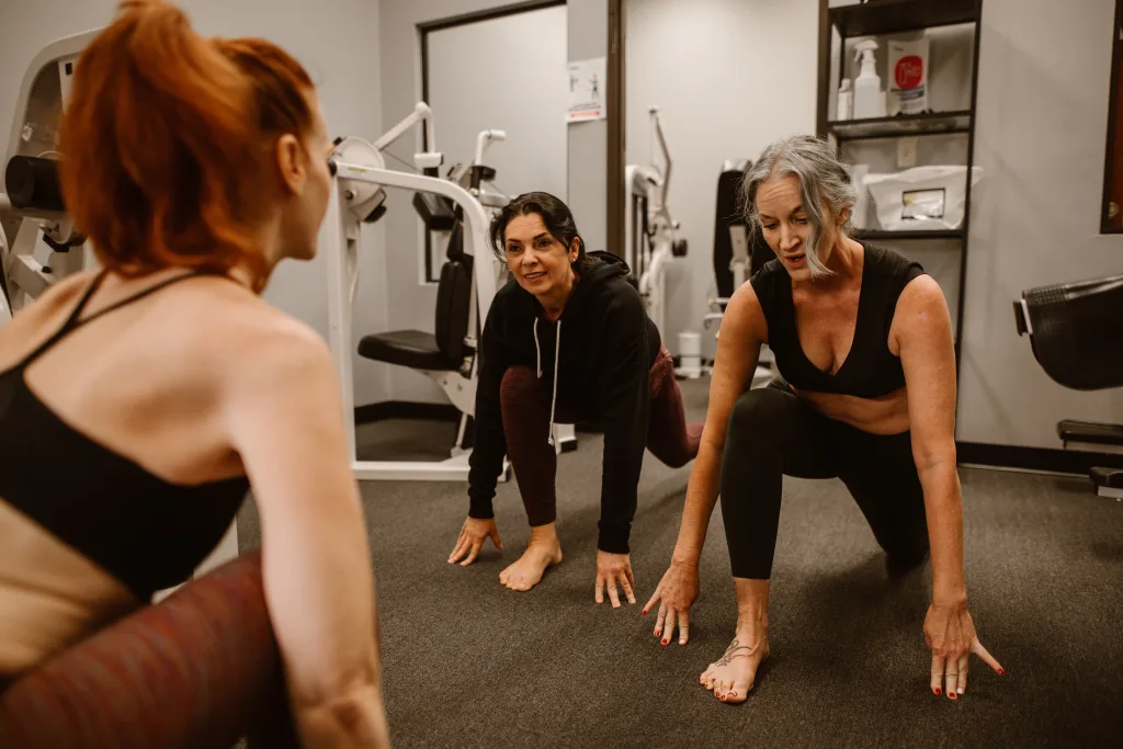 Group of women kneeling on the ground inside the facility