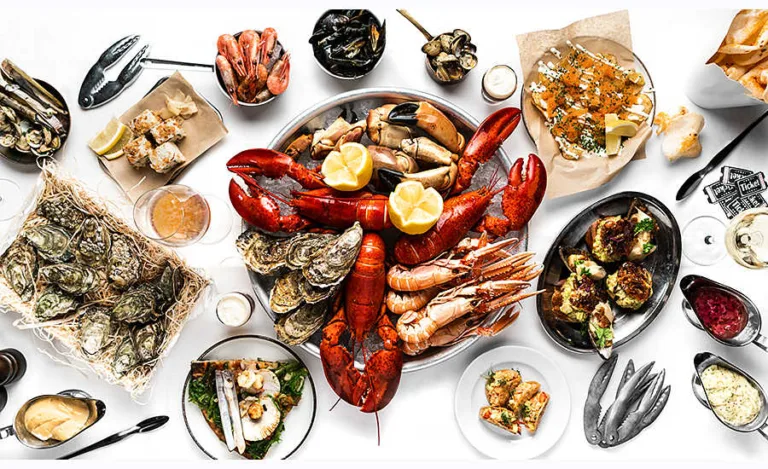 Crayfish and seafoods table top view. Lobsters, crayfish, shrimps, clams, oysters, sushi. On a white tablecloth