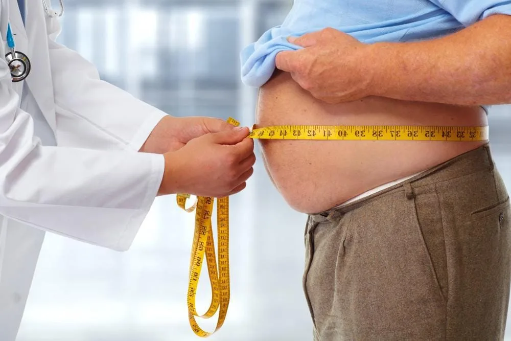 man being measured for weight loss injection