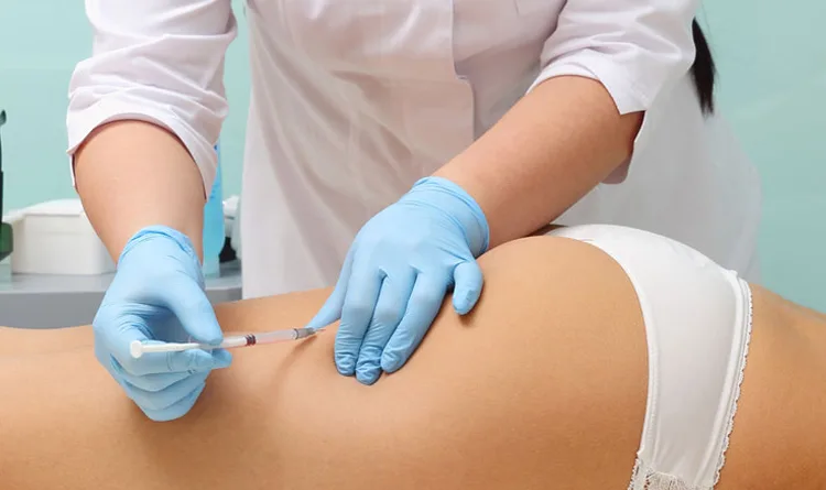 doctor applying medical prescription weight loss injection to a woman