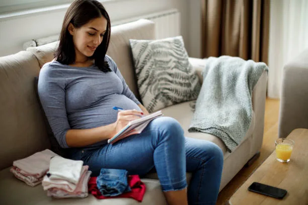 mother listing down things in preparation for childbirth