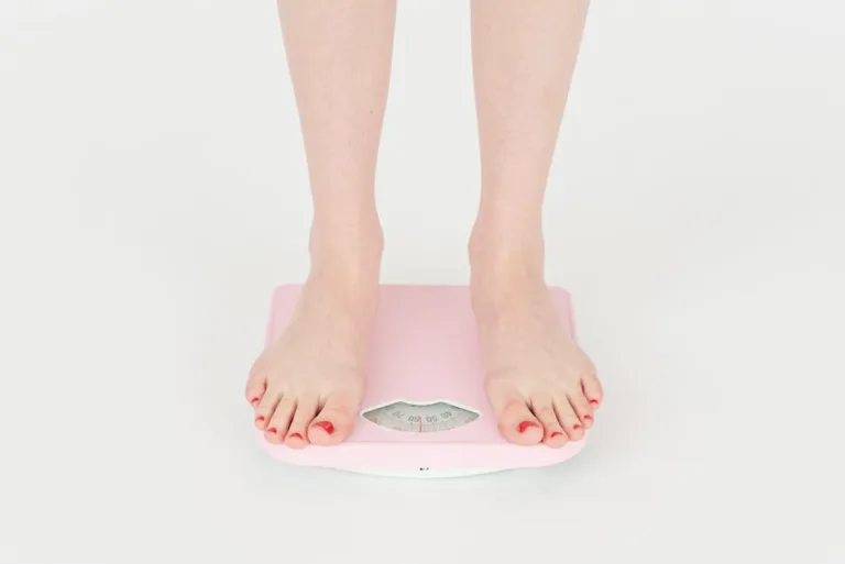 weight loss woman in weighing scale underfueling