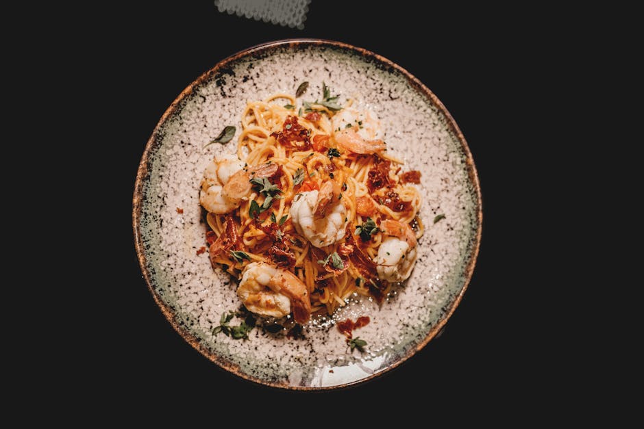 A plate of whole-grain linguine with marinara sauce, shrimp, and vegetables