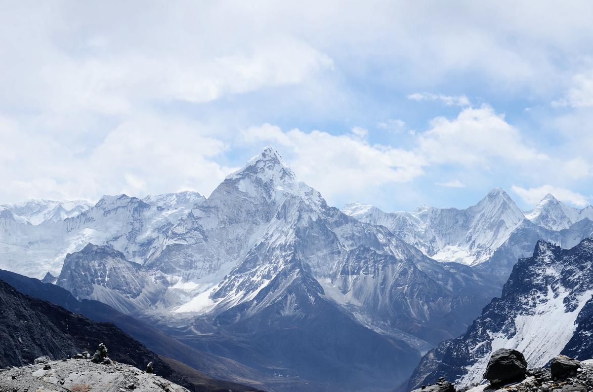 Image depicting the initiation into a weight loss journey, showing a person standing on top of a mountain, symbolizing their determination and readiness to embark on the journey.